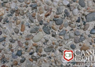 Exposed Off white Concrete Floor With Riverbed Gravel