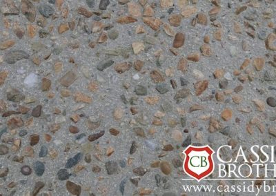 Exposed Off white Concrete Floor With Riverbed Gravel